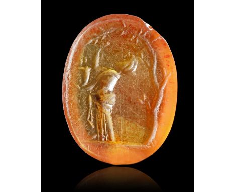 A carnelian intaglio showing a woman picking fruit from a tree which arches over her. She holds a cornucopia which suggests t