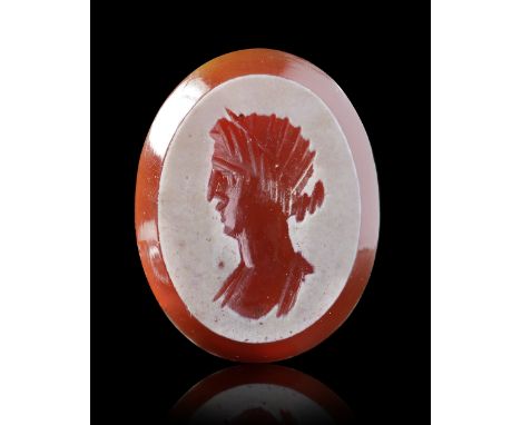 A Roman intaglio showing the bust of a woman facing left. She is draped and although the wheel cut technique does not allow f