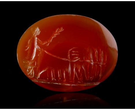 A Roman carnelian intaglio showing and Elephant quadriga walking towards the left. In the chariot there appears to be a man h