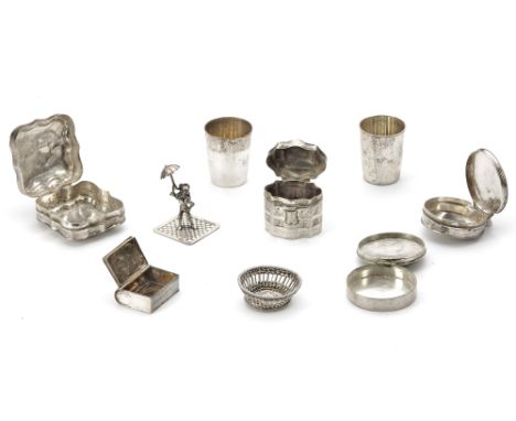 Four silver pill boxes and a 'l'eau de reine silver snuff box together with two silver drinking cups and a silver miniature o