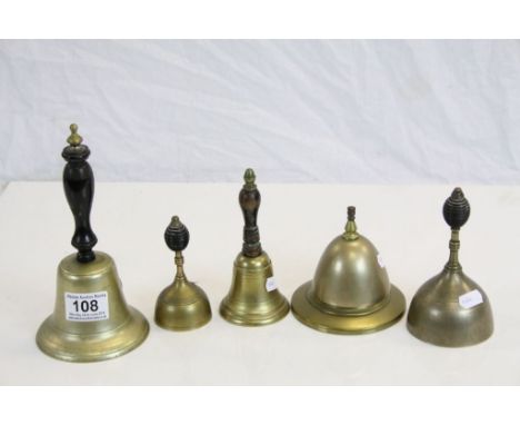 Four vintage Bronze hand Bells with ebonised Wooden handles plus a similar Counter top example