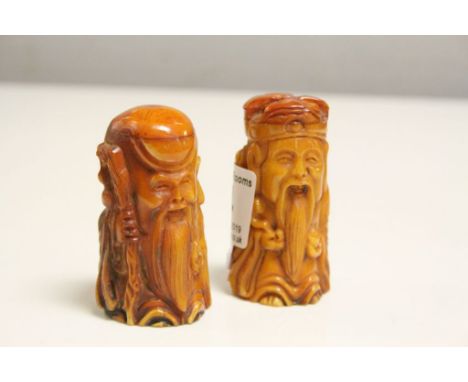 Two bone netsuke figures to include a man with gold and a traveller 