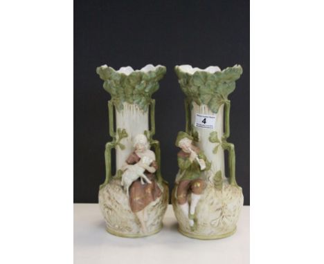 Pair of twin handled Royal Dux ceramic Vases, one with Man playing a Flute, the other with Female holding a Lamb, both with P