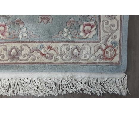 CHINESE FLOOR RUG, in light blue, with floral decoration and fringed edge156cm x 92cm