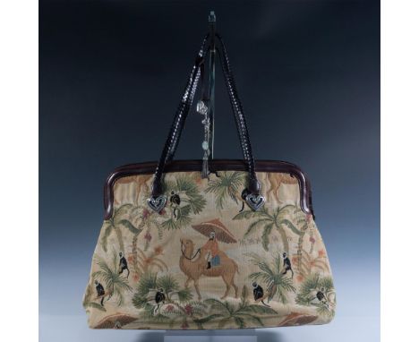 Tapestry decorated with safari or Sahara scene palm trees, camels, and monkeys. Leather banding and braided shoulder straps. 
