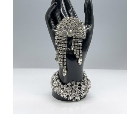 This pair of sparkling rhinestone jewelry features a stunning braided bracelet with prong set stones and a fantastic chandeli