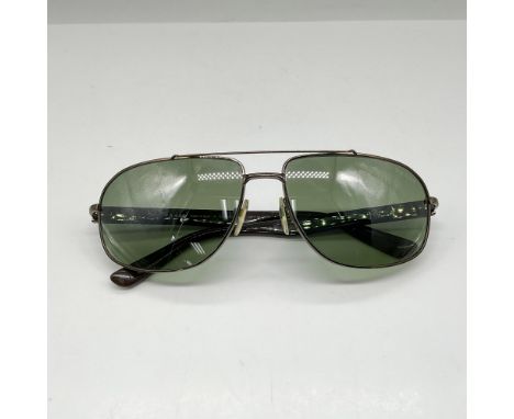 Bronze metal rim with green polarized tinted lenses. Prada mark. This item has its original box: 6.75"L x 3"W x 2.75"H. Certi