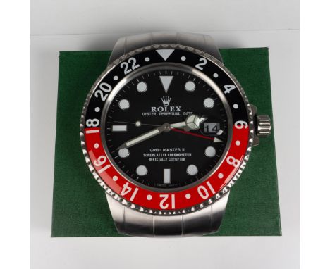 New in Box - Dealers wall display battery operated clock colored in red and black. Face has Rolex Crown mark with Oyster Perp