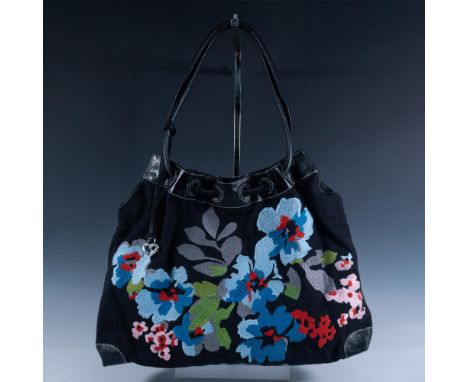 Black background with bright blue orchids and pink blossom motif canvas handbag with black leather. Cinch top closure. Red fa