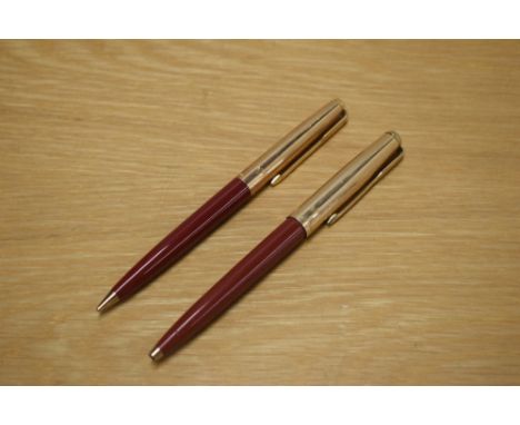 A Parker 61 ballpoint pen and propelling pencil in Rage Red with Rolled Gold cap