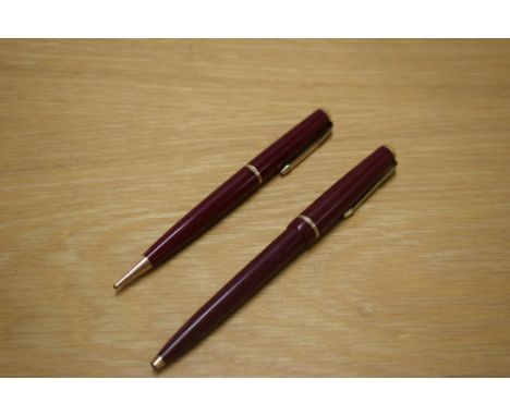 A Parker Duofold Ballpoint pen and Propelling Pencil in Burgundy with single narrow decorative band