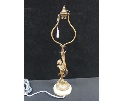 AN ORMOLU TABLE LAMP a cherub holding the acanthus leaf sprouting stem, on marble base 48cm high including integral shade hol