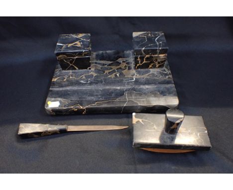 AN ART DECO MARBLE INKSTANDwith matching blotter and letter opener 30cm wide (lacking hinges to inkwell covers)