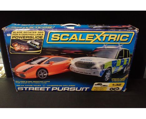 BOXED SCALEXTRIC 'STREET PURSUIT' SETScalextric Street Pursuit in 1/32nd scale to include Police Range Rover, with working si