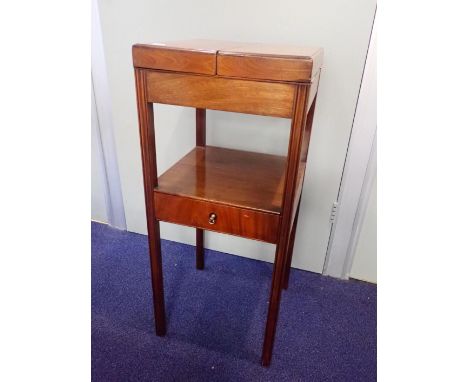 A GEORGE III MAHOGANY WASHSTANDthe basin hole enclosed with fold-over top, with drawer below, on straight moulded legs 34cm w