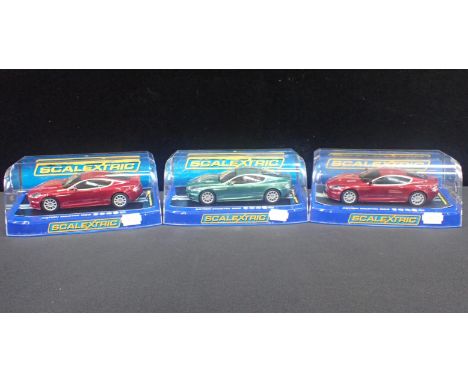 THREE BOXED SCALEXTRIC 'ASTON MARTIN DBS' CARSall boxed and in good condition. (3)