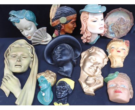 A GOEBEL WALL MASK, DATED 195923cm long, a collection of Art Deco plaster wall masks and similar items, the largest 54cm long