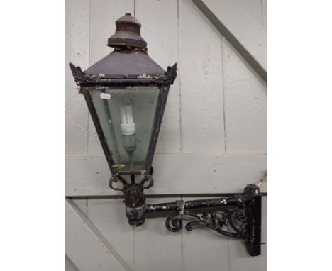 A WALL-MOUNTED GARDEN LIGHTin the style of a Victorian street lamp, with cast bracket (for re-wiring)