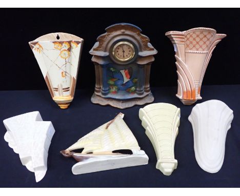 A COLLECTION OF ART DECO CERAMIC WALL POCKETSa similar yacht plaque, and a painted mantel clock