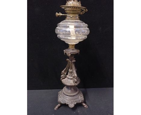 A VICTORIAN OIL LAMP WITH CAST IRON BASEin Neoclassical style, and cut glass reservoir (one palmette missing, no shade)
