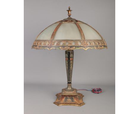 An Art Nouveau table lamp. With painted metal base and original milch glass panelled shade. The three bulb sockets stamped fo