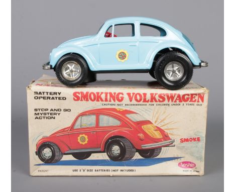 A 1970s Aoshin battery operated tin plate Smoking Volkswagen.