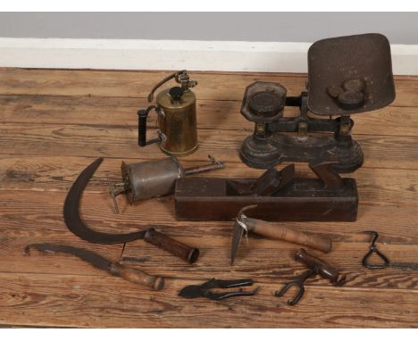 A box of mostly vintage hand tools to include wooden plane, sickle, weighing scales, etc.