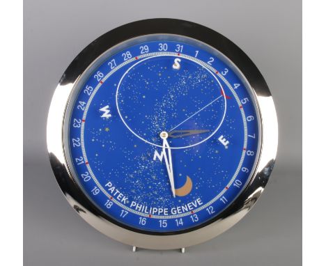 A Patek Philippe watch style wall clock, featuring a silver bezel and blue celestial dial.  Quartz movement, working, diamete