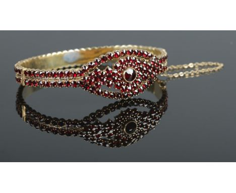 A vintage Bohemian Biedermeier garnet hinged bangle. Stamped 800 to clasp. Interior measurements 6.5cm x 5cm.