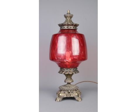 A vintage brass lamp with large cranberry glass shade. Height 61cm.