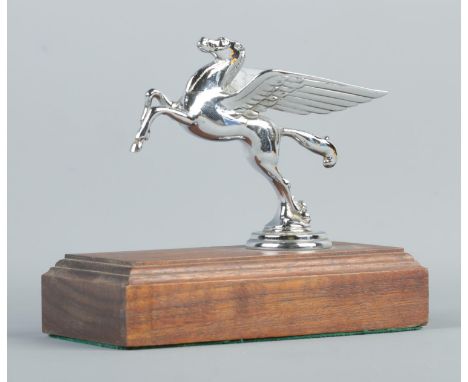 A chrome plated Mobil Oil hood/car mascot in the form of a Pegasus. Raised on stepped mahogany base. Height 13cm, Length 15cm