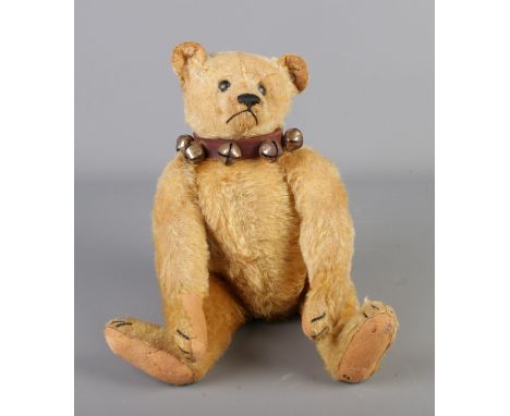 An early 20th century centre seam Steiff mohair jointed bear. With ear stud and bell collar. Seated height 27cm. Overall leng