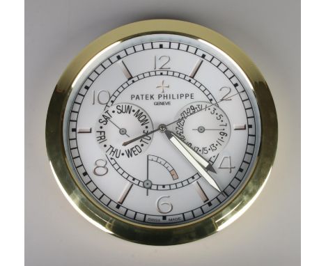 A Patek Philippe watch style wall clock, featuring a gold bezel and grey dial.