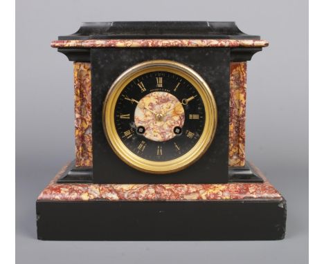 A small 19th century French slate and marble mantel clock. Having Roman numeral markers, movement by Brysons &amp; Son, Paris