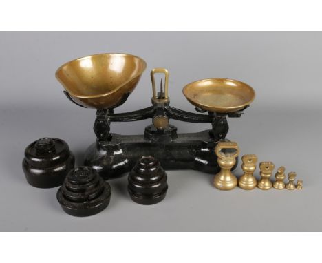 A vintage Libra Scale Co. England kitchen balance scales, with two sets of weights.