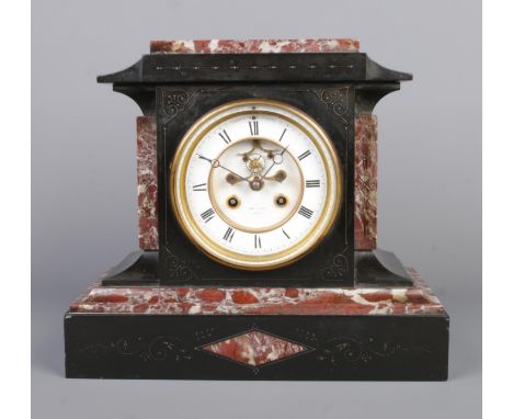 A 19th century French slate and marble mantel clock by Henry Marc, Paris. Having Roman numeral markers, visible anchor escape