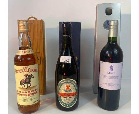 A bottle of the national choice red rum fine old blended scotch whisky, a bottle of claret Scottish parliament chateau lagren