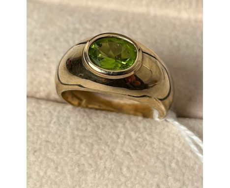 9ct yellow gold ring set with an oval cut green tourmaline gem stone. [Ring size Q] [5.18Grams] 