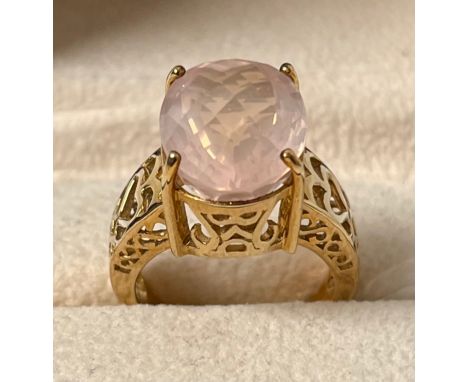 9ct yellow gold ring set with an oval cut pink gem stone. [Ring size N] [7.32Grams] 