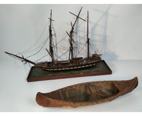 A model of a British boat on stand along with a Native American boat model [77.5cm] 
