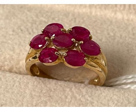 9ct yellow gold ring set with seven oval cut ruby stones. [Ring size N] [3.50Grams] 