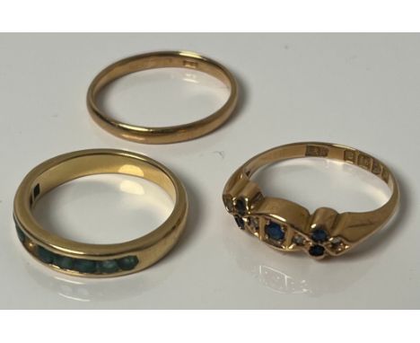 Three various 18ct yellow gold rings; 18ct gold wedding band- ring size M, 18ct gold, diamond and blue stone ring- missing di