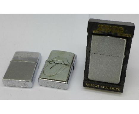 Three Zippo lighters including one with Rolling Stones logo