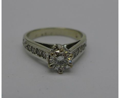 A diamond ring, 0.65 carat main stone, approximately 0.90 carat total, 2.7g, J