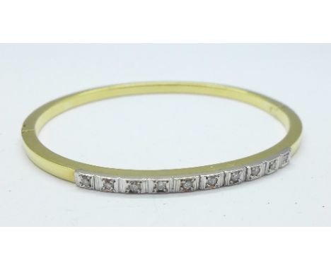 An 18ct gold bangle, marked 750, set with ten diamonds, 9.5g