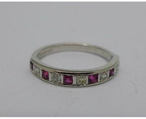 An 18ct white gold, ruby and diamond half eternity ring, 2.6g, M