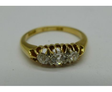 An 18ct gold and three stone diamond ring, 3g, K