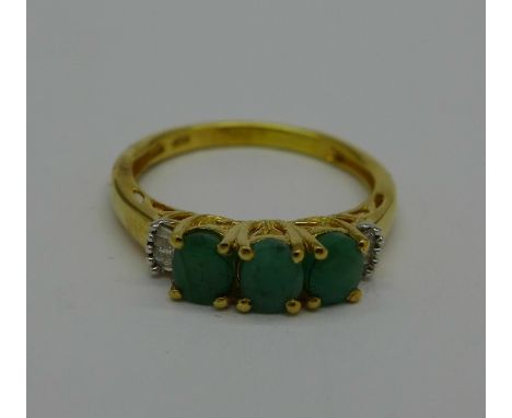 A silver gilt, emerald and diamond ring, Q