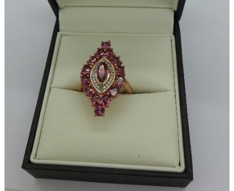 A silver gilt, pink stone and diamond ring, Q