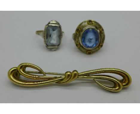 A yellow metal and blue stone ring, one other ring with a blue stone marked 333 and a brooch, weight of rings 7.3g, K and L